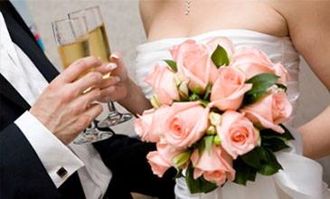 Image of a bride and groom holding champagne