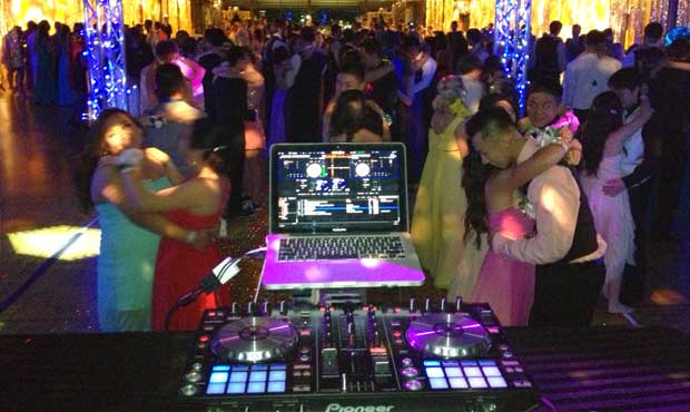view of a school dance from behind the dj booth